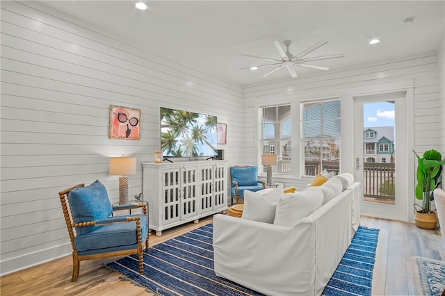 sunroom / solarium featuring ceiling fan