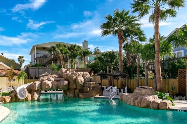 view of swimming pool with a water slide