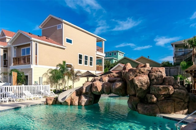 view of swimming pool with a water slide