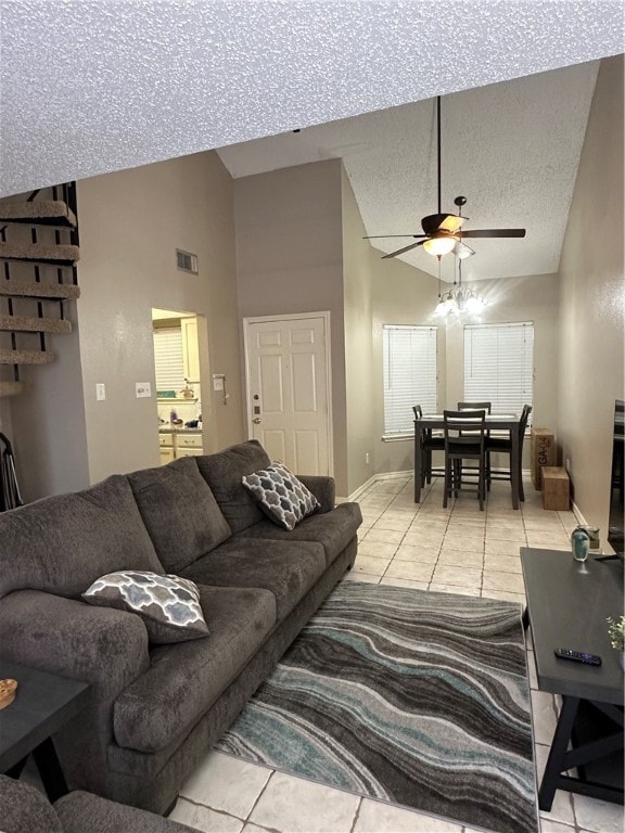 living room featuring a textured ceiling, ceiling fan, high vaulted ceiling, and light tile patterned floors