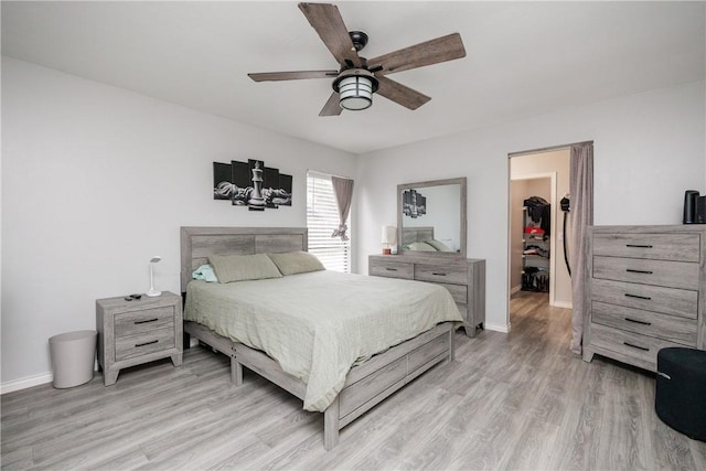 bedroom with ceiling fan and light wood-type flooring