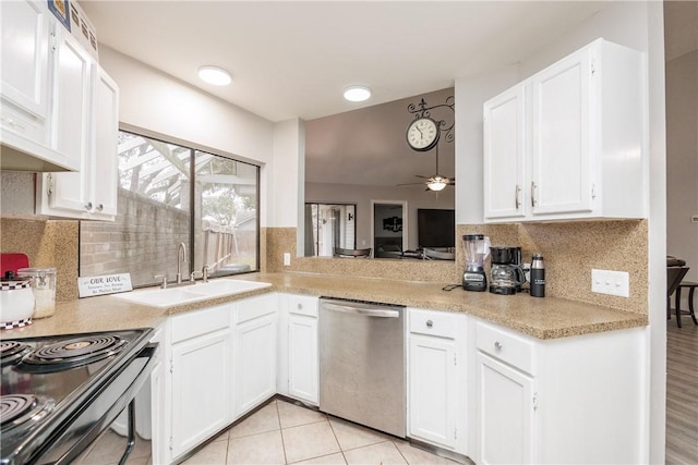 kitchen featuring sink, range with electric cooktop, white cabinets, decorative backsplash, and stainless steel dishwasher