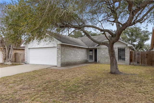 ranch-style home featuring a garage and a front yard