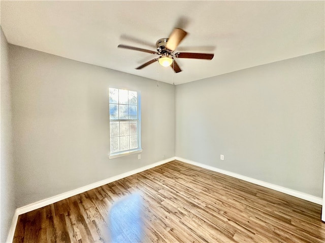 spare room featuring hardwood / wood-style flooring and ceiling fan