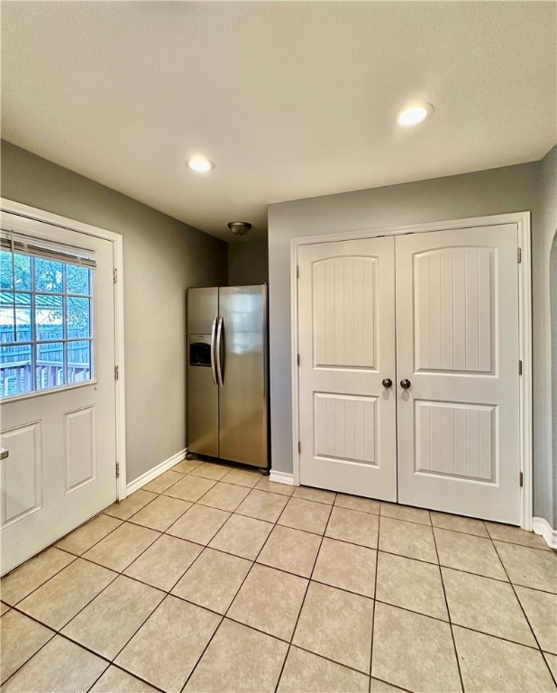 kitchen featuring stainless steel fridge and light tile patterned floors