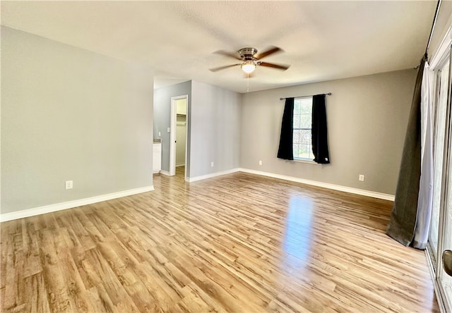 spare room with ceiling fan and light hardwood / wood-style floors