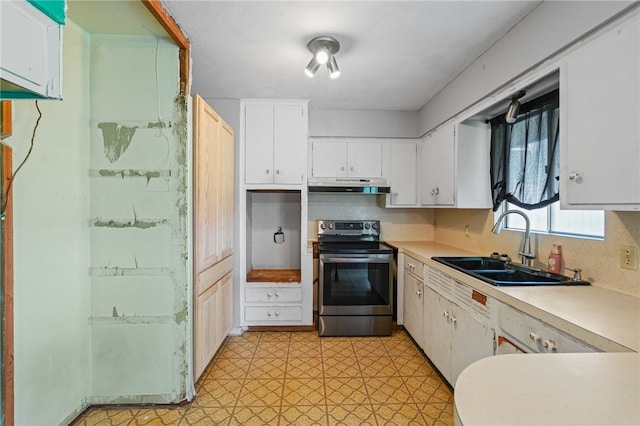 5725 Woodhaven Dr, Corpus Christi, TX 78412 - kitchen with electric stove, under cabinet range hood, light floors, light countertops, and white cabinetry