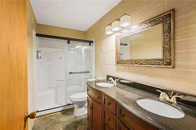 5725 Woodhaven Dr, Corpus Christi, TX 78412 - bathroom with tile walls, a stall shower, double vanity, and decorative backsplash