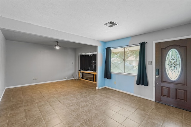 5725 Woodhaven Dr, Corpus Christi, TX 78412 - foyer entrance with plenty of natural light, ceiling fan, a textured ceiling, and tile patterned floors