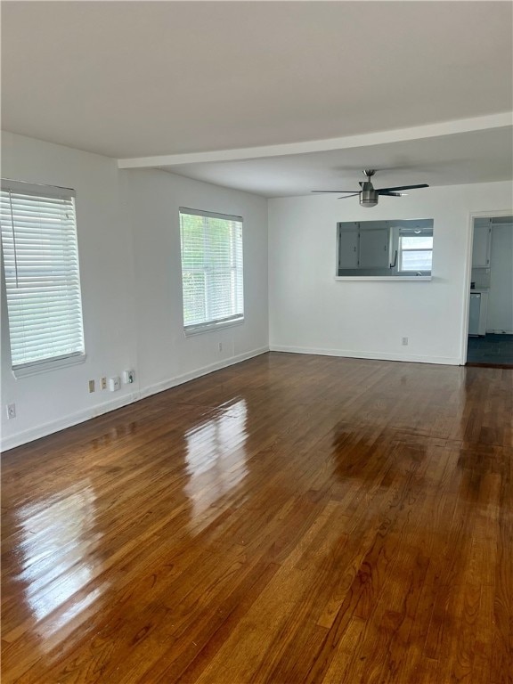 spare room with dark wood-type flooring and ceiling fan