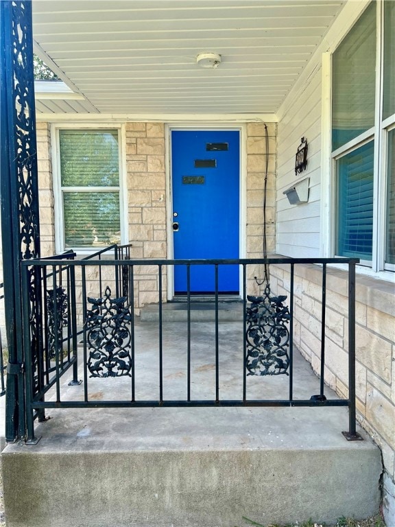 doorway to property featuring covered porch