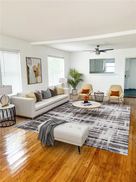 living room featuring hardwood / wood-style floors and ceiling fan