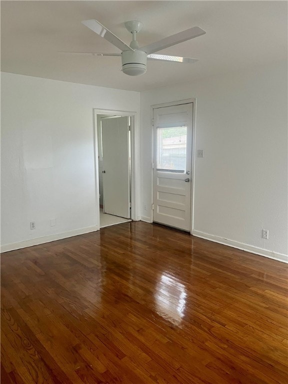 empty room featuring dark hardwood / wood-style flooring and ceiling fan