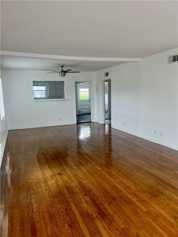 unfurnished living room with ceiling fan and dark hardwood / wood-style floors