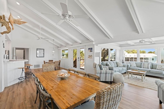 13 Sandpiper Ln, Rockport, TX 78382 - dining area featuring a ceiling fan, beamed ceiling, light wood-type flooring, and high vaulted ceiling