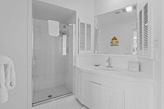 13 Sandpiper Ln, Rockport, TX 78382 - full bathroom with a shower stall, vanity, and backsplash