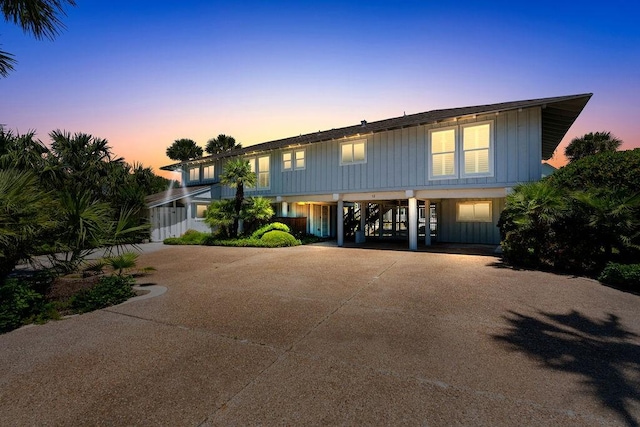 13 Sandpiper Ln, Rockport, TX 78382 - raised beach house featuring a carport, board and batten siding, and driveway