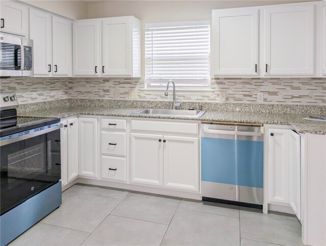 3022 Chapel Creek Dr, Corpus Christi, TX 78414 - kitchen featuring white cabinetry, stainless steel appliances, tasteful backsplash, and a sink