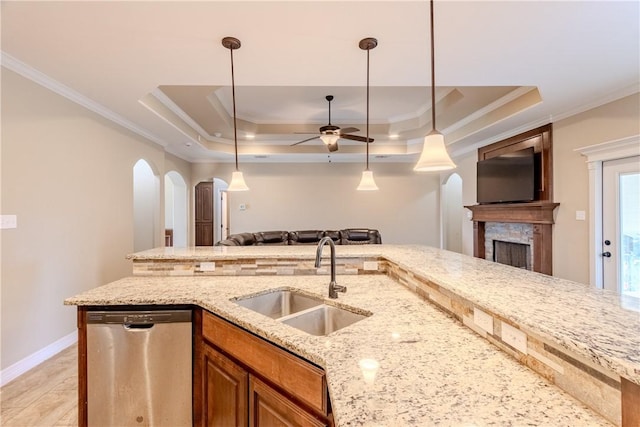 kitchen with a sink, crown molding, open floor plan, and dishwasher