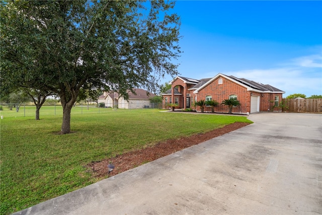 view of front of home featuring a front lawn, a garage, and solar panels