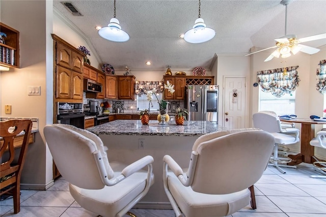 7206 Gold Ridge Rd, Corpus Christi, TX 78413 - kitchen with stainless steel appliances, crown molding, tasteful backsplash, light tile patterned floors, and ceiling fan