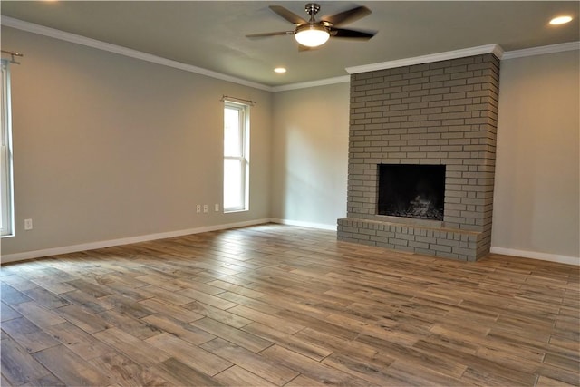 unfurnished living room featuring a fireplace, light hardwood / wood-style flooring, and crown molding