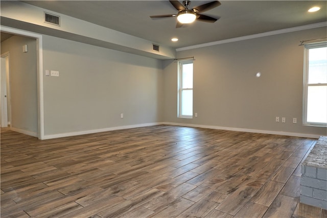 spare room with wood-type flooring, ceiling fan, and crown molding