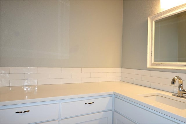 bathroom featuring decorative backsplash and sink