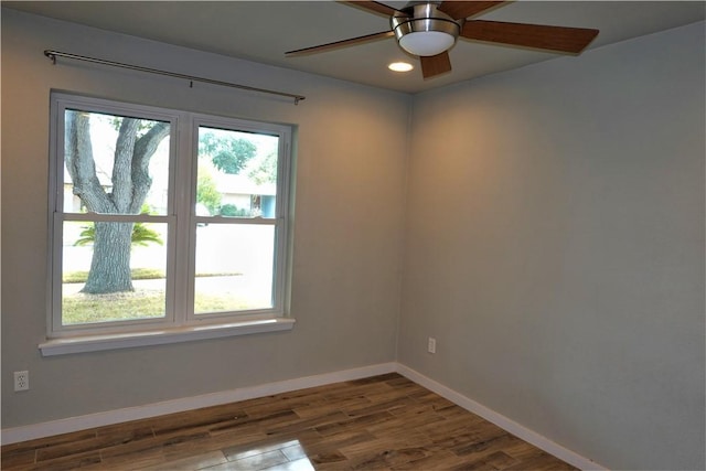 unfurnished room with dark hardwood / wood-style flooring and ceiling fan