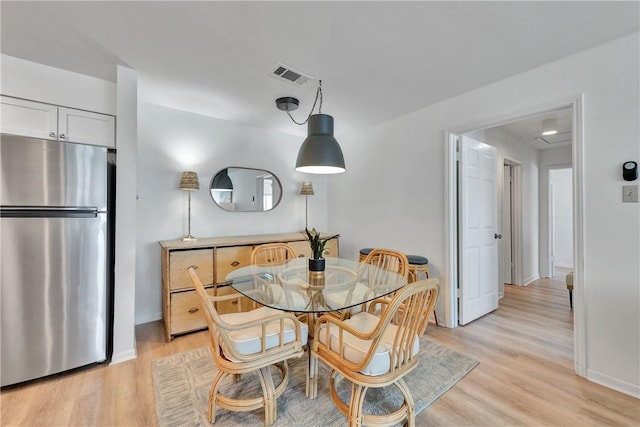 dining space featuring light hardwood / wood-style floors