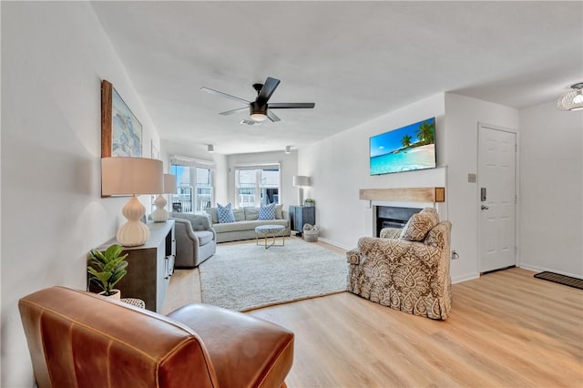 living room with hardwood / wood-style floors and ceiling fan