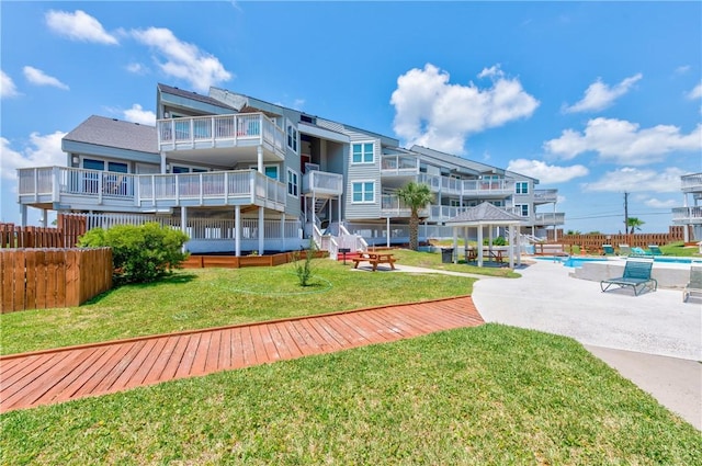 surrounding community with a lawn and a patio