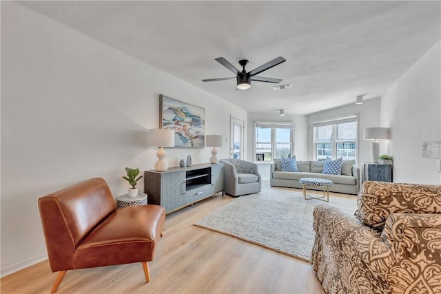 living room with light wood-type flooring and ceiling fan