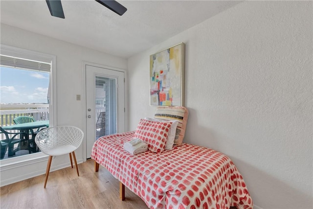 bedroom with light hardwood / wood-style flooring and ceiling fan