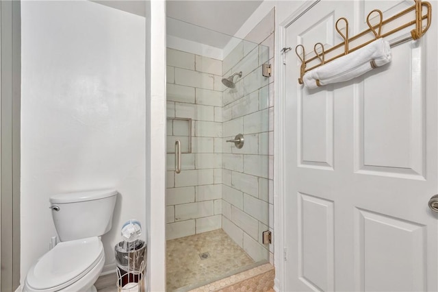 bathroom featuring an enclosed shower and toilet