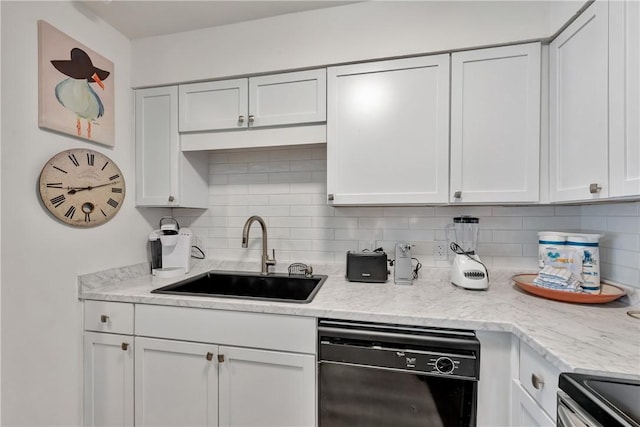 kitchen featuring decorative backsplash, sink, white cabinets, and black dishwasher