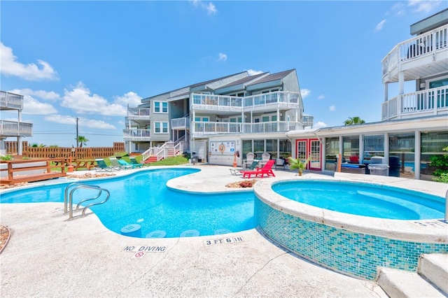 view of swimming pool with a patio and a hot tub