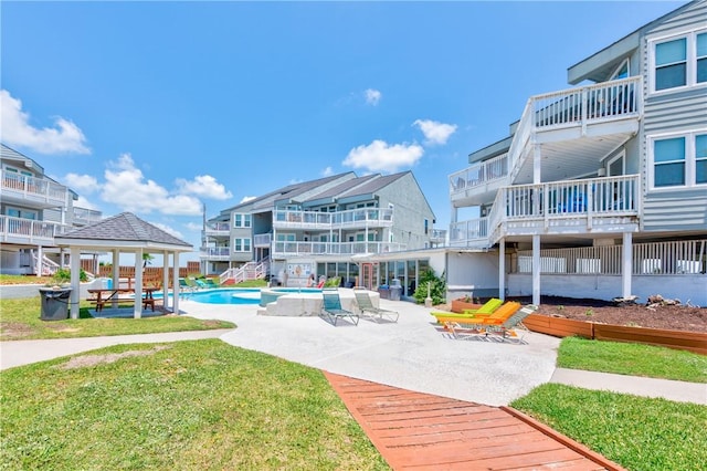 surrounding community featuring a lawn, a gazebo, a patio, and a pool