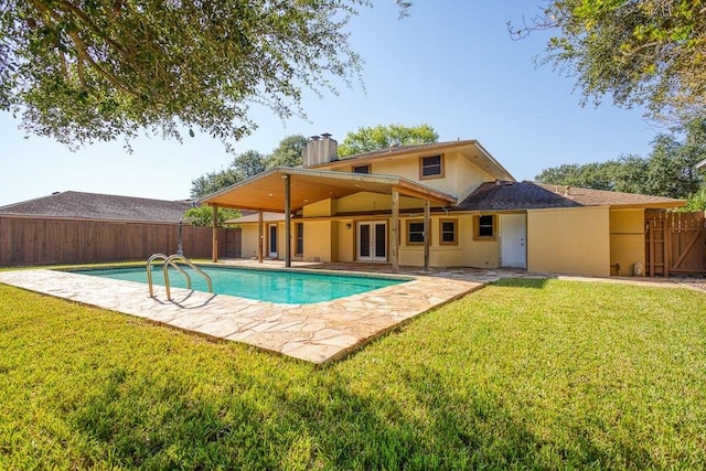 view of pool featuring a lawn and a patio area