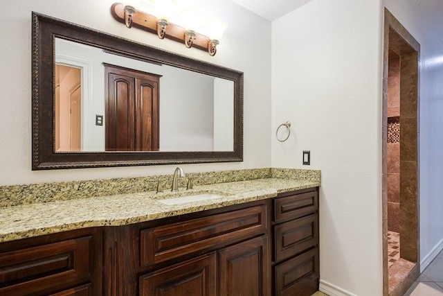 bathroom with walk in shower and vanity