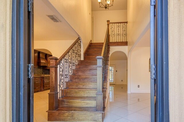 stairs featuring tile patterned flooring