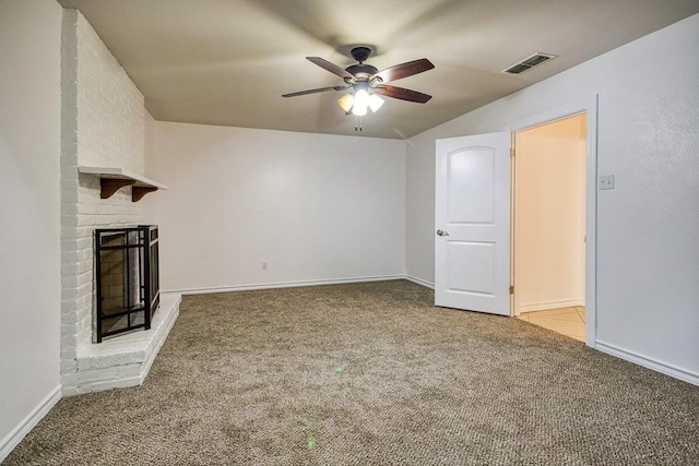 unfurnished living room with a brick fireplace, light carpet, and ceiling fan