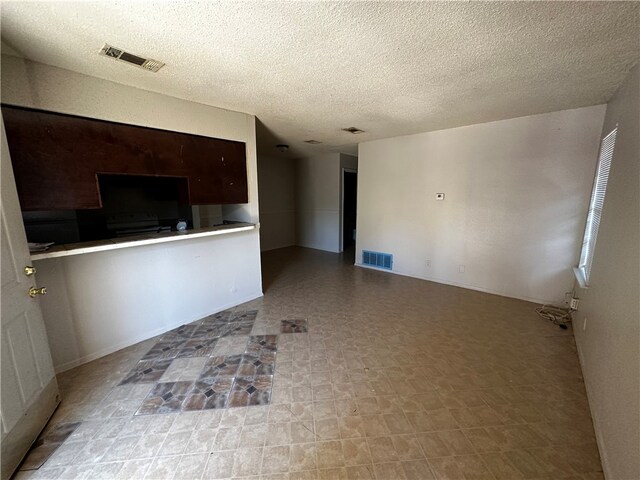 unfurnished living room featuring a textured ceiling