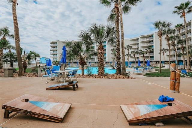 view of property's community featuring a patio and a pool