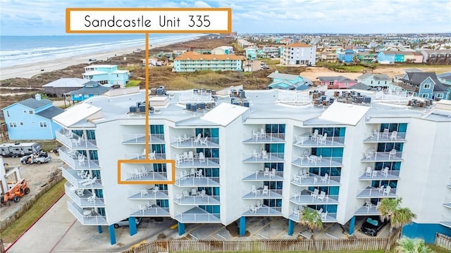 drone / aerial view featuring a beach view and a water view