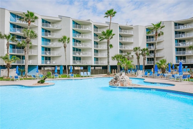 view of pool with a hot tub