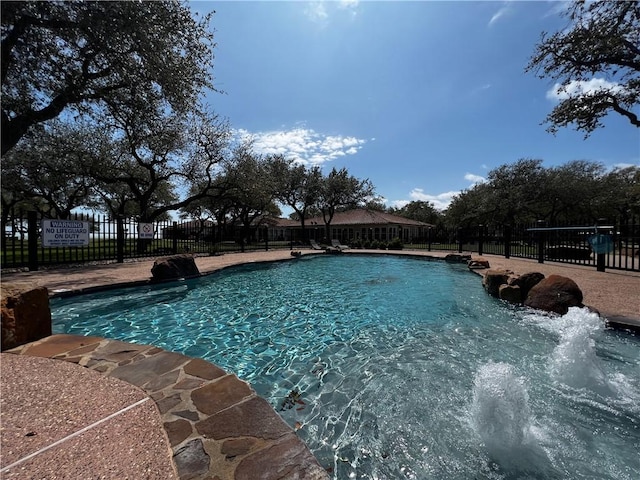 view of swimming pool with a fenced in pool and fence