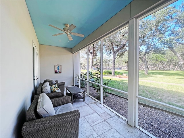 sunroom / solarium with a ceiling fan