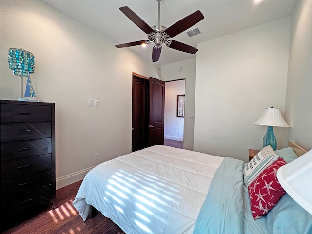 bedroom with visible vents, ceiling fan, baseboards, and wood finished floors