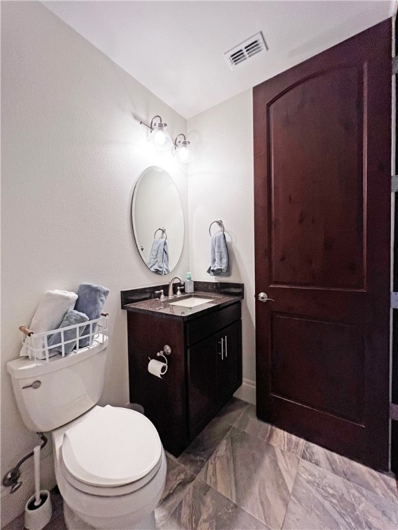 bathroom with visible vents, marble finish floor, toilet, and vanity